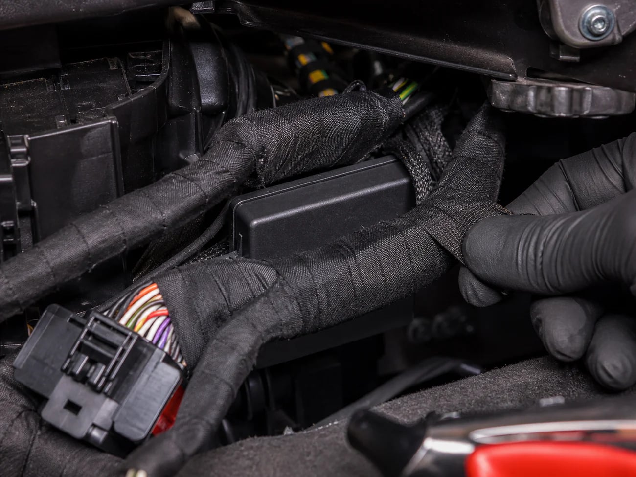 Ghost immobiliser module concealed within a vehicle wiring loom, invisible to thieves