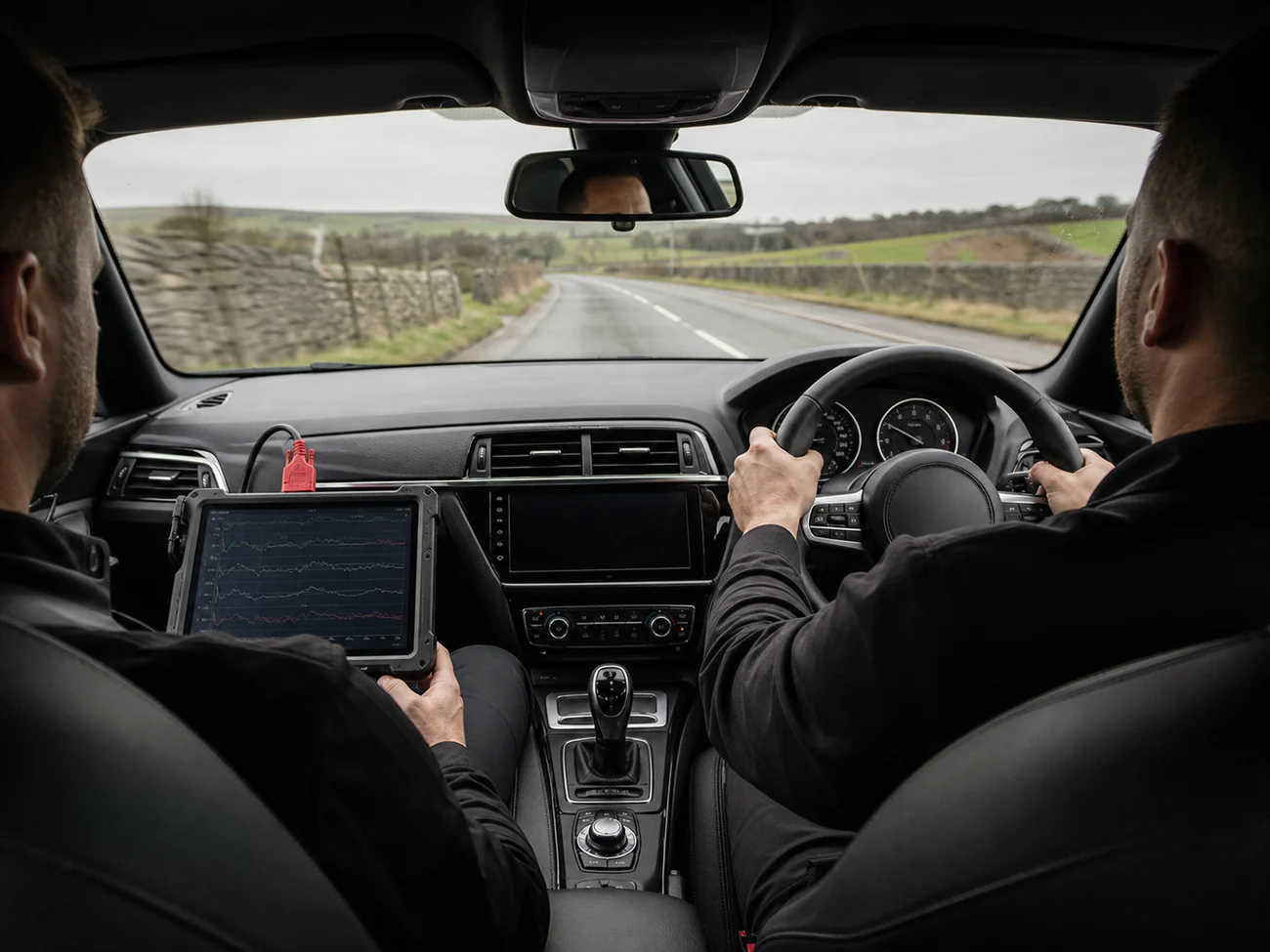 Technician road testing a remapped vehicle while logging live engine data